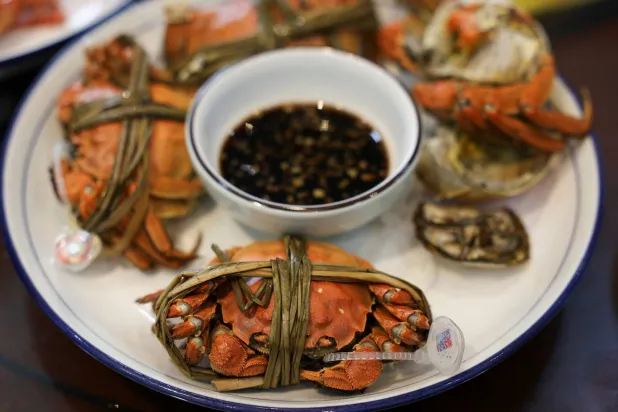Steamed hairy crabs sit on a plate in Suzhou, Jiangsu province, China, October 21, 2025. (Reuters)