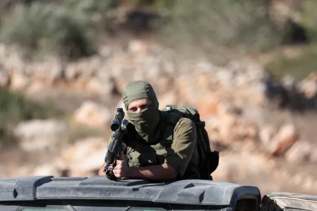 İşgal altında bulunan Batı Şeria'daki Ramallah yakınlarında nöbet tutan bir İsrailli güvenlik görevlisi (Reuters)