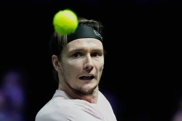 Alexander Bublik of Kazakhstan returns the ball to Taylor Fritz of the United States of during their third round match at the Paris Masters tennis tournament in Paris, France, Thursday, Oct. 30, 2025. (AP Photo/Michel Euler)