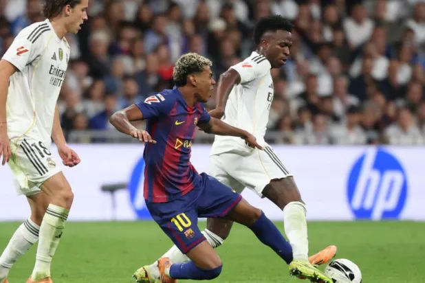 Vinicius Junior and Lamine Yamal fight for the ball during last weekend's Clasico, in which Real Madrid beat Barcelona 2-1. Oscar DEL POZO / AFP/File
