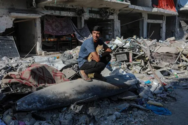 An Israeli missile lays on the rubble in the middle of a street next to destroyed houses in Gaza City, Gaza Strip, 30 October 2025, amid a ceasefire between Israel and Hamas. (EPA) 