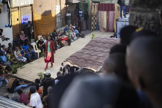 Models show off outfits created by local fashion designers specialising in upcycling discarded fabrics and garments from second-hand clothes markets. Tony KARUMBA / AFP