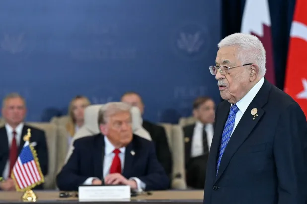 Palestinian President Mahmoud Abbas (R) walks past US President Donald Trump during a summit on Gaza in Sharm El-Sheikh on October 13, 2025. (AFP) 