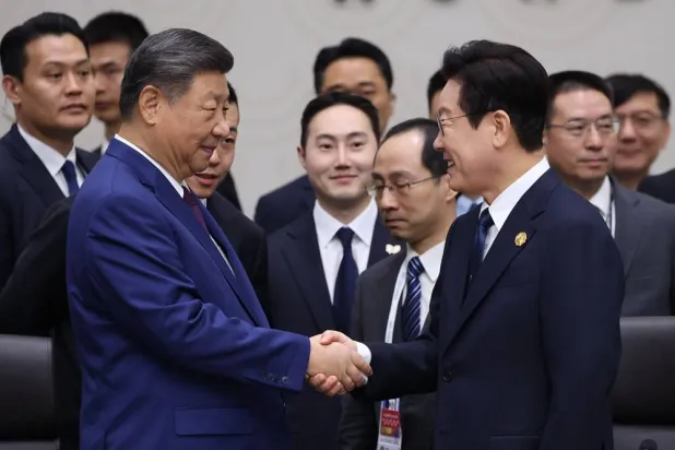 South Korean President Lee Jae Myung (R) shakes hands with Chinese President Xi Jinping (L) during the second session of the APEC Economic Leaders' Meeting (AELM), as part of the Asia-Pacific Economic Cooperation (APEC) summit in Gyeongju, South Korea, 01 November 2025. (EPA/Yonhap)