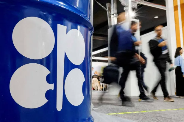 FILE PHOTO: People walk past an installation depicting a barrel of oil with the logo of the Organization of the Petroleum Exporting Countries (OPEC) during the COP29 United Nations climate change conference in Baku, Azerbaijan, November 19, 2024. REUTERS/Maxim Shemetov/File Photo/File Photo