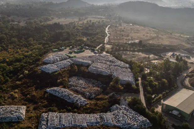 Plastic-wrapped waste bales stored outside a recycling plant on the Greek island of Corfu, part of a groundbreaking waste-management program. Angelos TZORTZINIS / AFP
