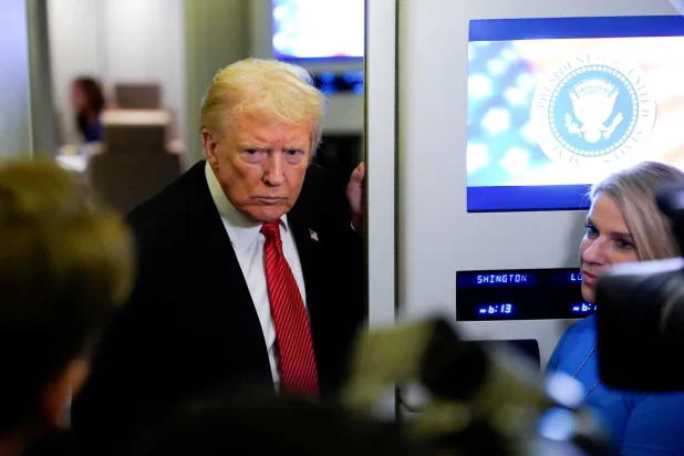 US President Donald Trump looks on as he speaks to members of the media on board Air Force One en route to Joint Base Andrews, US, November 2, 2025. (Reuters) 