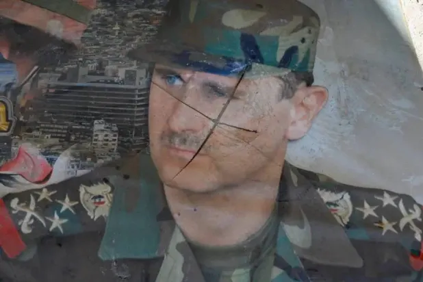 A portrait of the president is defaced at Syria’s Palestine Branch prison, where piles of documents of interrogations and reports, and its dark, dank collection of cells, shows the systematic cruelty of the toppled regime of Bashar al-Assad, in Damascus, Syria on December 17, 2024. (Getty Images) 