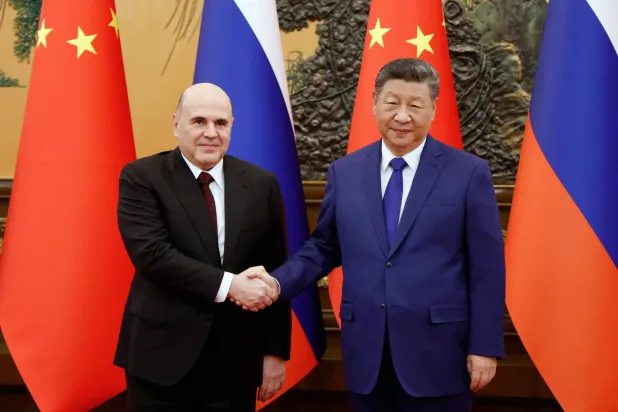 Russian Prime Minister Mikhail Mishustin (L) is welcomed by Chinese President Xi Jinping before a meeting at the Great Hall of the People in Beijing, China, 04 November 2025. (EPA/ Dmitry Astakhov/Sputnik/Government Press Service / Pool) 