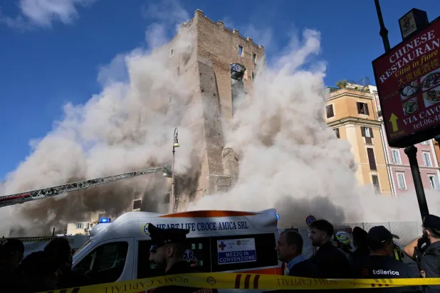 Dust rises due to a second collapse of part of the medieval tower "Torre dei Conti" near the Roman Forum in the historic center of Rome on November 3, 2025. (AFP)