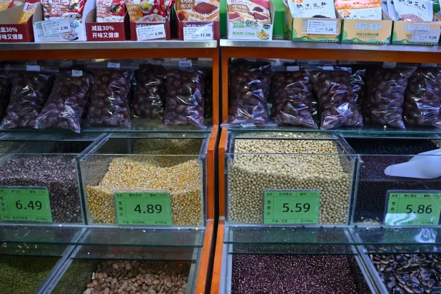 This picture shows grains including Chinese local product of premium soybeans (2nd-R) from Jiangsu province, at a supermarket in Beijing on November 5, 2025. (AFP)