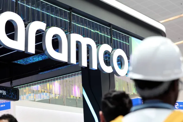 People visit the Saudi Arabian Oil Company (Aramco) stand during the Abu Dhabi International Petroleum Exhibition and Conference (ADIPEC) in Abu Dhabi, United Arab Emirates, 03 November 2025. (EPA)