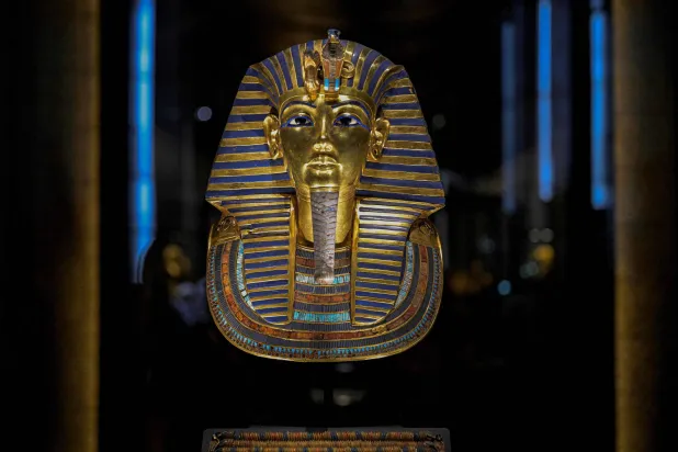 The golden funerary mask of ancient Egyptian King Tutankhamun is displayed inside the Tutankhamun Gallery at the Egyptian Grand Museum near the Giza pyramids in Cairo on November 4, 2025. (AFP)