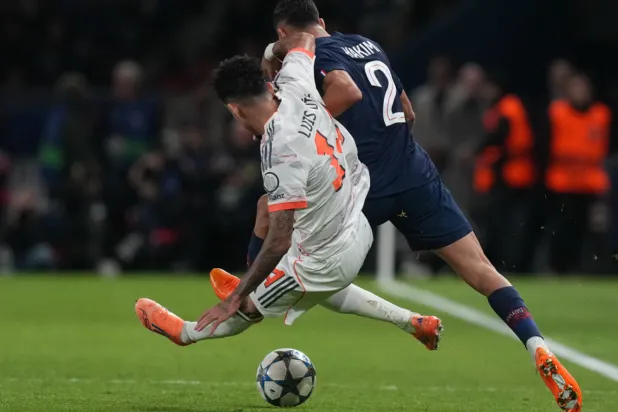 Bayern's Luis Diaz fouls PSG's Achraf Hakimi during the Champions League opening phase soccer match between Paris Saint-Germain and Bayern Munich in Paris, France, Tuesday, Nov. 4, 2025.(AP Photo/Thibault Camus)