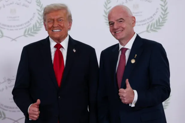 President Donald Trump and FIFA president Gianni Infantino pose for a photo in Sharm el-Sheikh, Egypt, Monday, Oct. 13, 2025. (Suzanne Plunkett, Pool Photo via AP)

