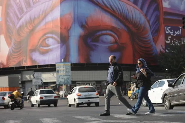 People walk past an anti-US billboard on a street in Tehran, Iran, November 5, 2025. Majid Asgaripour/WANA (West Asia News Agency) via Reuters