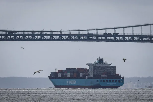 FILE PHOTO: Containers are stacked on the deck of cargo ship Maersk Monte Alegre under the Verrazzano-Narrows Bridge to enter New York Harbor as seen from Manhattan in New York City, US, April 2, 2025. REUTERS/Jeenah Moon/File Photo