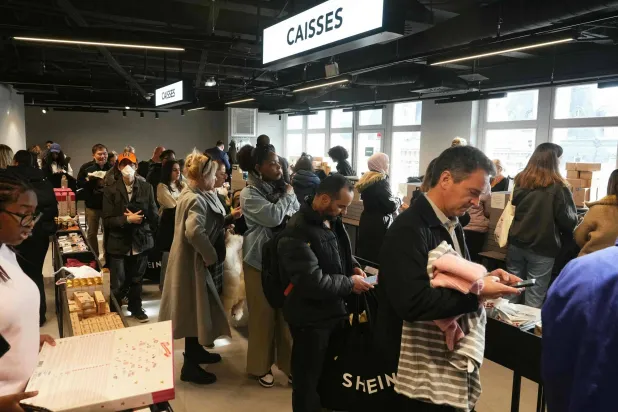Costumers shops on the opening day of Asian e-commerce giant Shein's first physical store at the Bazar de l'Hotel de Ville (BHV) department store in Paris on November 5, 2025. (Photo by Dimitar DILKOFF / AFP)