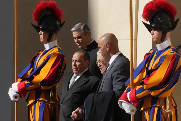 Palestinian President Mahmoud Abbas, also known as Abu Mazen, center, leaves the St. Damasus Courtyard at the Vatican after meeting with Pope Leo XIV, Thursday, Nov. 6, 2025. (AP Photo/Andrew Medichini)