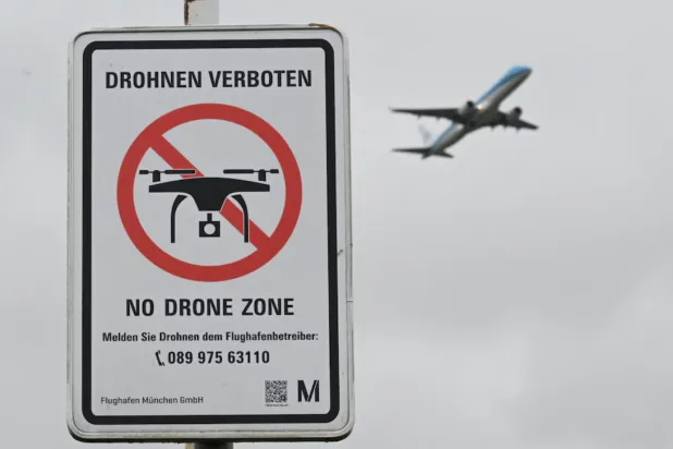 A sign with a drone ban is displayed outside the airport in Munich, Germany October 6, 2025. REUTERS/Angelika Warmuth/File 