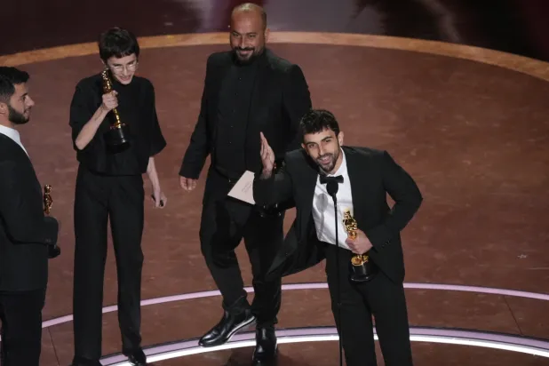 Basel Adra, from left, Rachel Szor, Hamdan Ballal, and Yuval Abraham accept the award for best documentary feature film for "No Other Land" during the Oscars on Sunday, March 2, 2025, at the Dolby Theatre in Los Angeles. (AP Photo/Chris Pizzello)