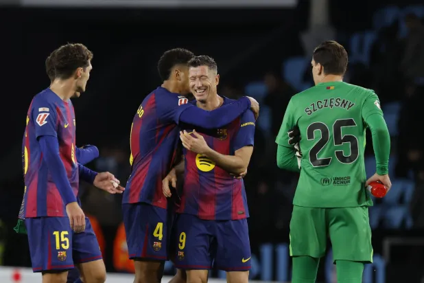 Barcelona's Robert Lewandowski celebrates with his teammate Ronald Araujo (C-L) after winning the Spanish LaLiga soccer match between Celta Vigo and FC Barcelona, in Vigo, Spain, 09 November 2025. (EPA)