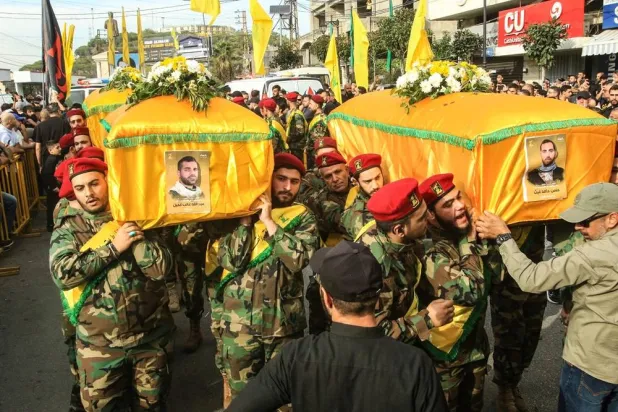 Members of Lebanon's group Hezbollah carry the coffins of comrades killed in recent Israeli attacks during their funeral in the southern city of Nabatiyeh on November 2, 2025. (AFP) 