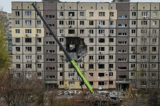 A crane works where several residential units have collapsed after an apartment building was hit during a Russian drone strike, amid Russia's attack on Ukraine, in Dnipro, Ukraine November 8, 2025. (Reuters)