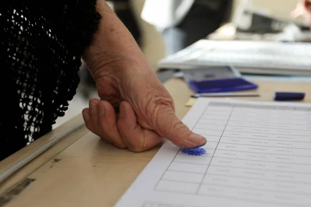 A person votes at a polling station during the parliamentary election in Kirkuk, Iraq, November 11, 2025. (Reuters)