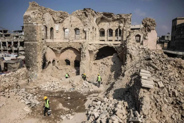 Workers in Gaza City clear rubble on Tuesday from the historic Al-Basha Palace, destroyed by the Israeli army (AFP)