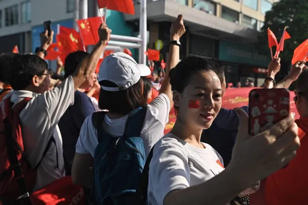 A woman takes a selfie during a pro-Beijing flash mob rally in Hong Kong on Oct. 1, 2019, to mark the 70th anniversary of communist China’s founding. (AFP via Getty Images)