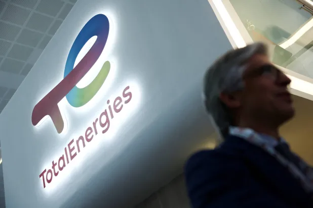 FILE PHOTO: A man walks past a logo of TotalEnergies during the annual energy industry event Abu Dhabi International Petroleum Exhibition and Conference (ADIPEC) in Abu Dhabi, United Arab Emirates, November 3, 2025. REUTERS/Amr Alfiky/File Photo