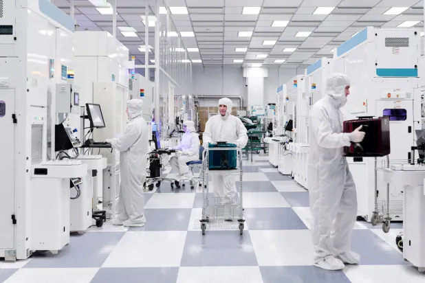 People work at a cleanroom that manufactures 300 millimeter silicon wafers containing quantum computing chips at the Albany NanoTech Complex in Albany, New York., US, in this handout image released on November 10, 2025. IBM/Handout via REUTERS 