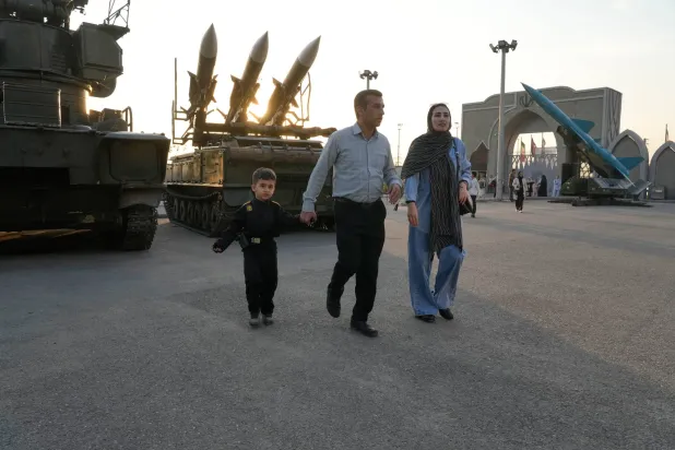 إيرانيون أمام الحديقة الجوية الفضائية الوطنية التابعة لـ«الحرس الثوري» في طهران يوم 13 نوفمبر (أ.ب)