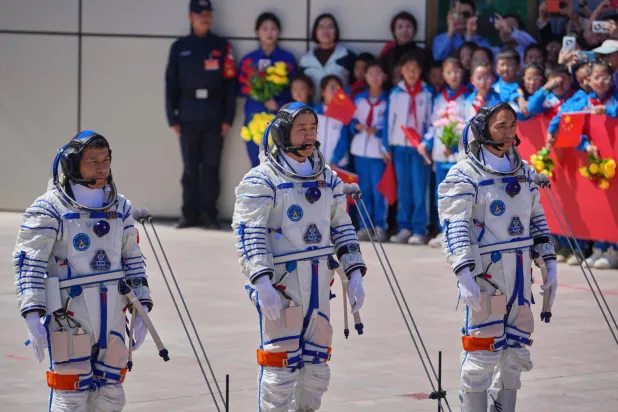 FILE - Chinese astronaut for the Shenzhou 20 mission, Chen Dong, center, speaks next to his comrades Chen Zhongrui, right, and Wang Jie as they attend a send-off ceremony for their manned space mission at the Jiuquan Satellite Launch Center in northwestern China, Thursday, April 24, 2025. (AP Photo/Andy Wong, file)