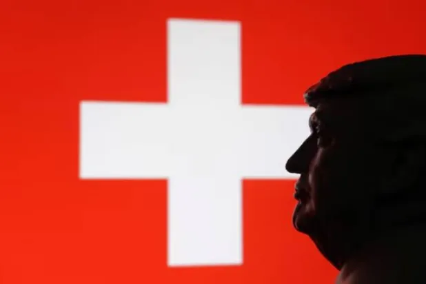 نموذج مصغر مطبوع بتقنية ثلاثية الأبعاد للرئيس الأميركي دونالد ترمب والعلم السويسري (رويترز)