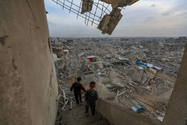Palestinian boys walk near their destroyed family house in the Sheikh Radwan neighborhood of Gaza City, Gaza Strip, 14 November 2025, amid a ceasefire between Israel and Hamas. (EPA)
