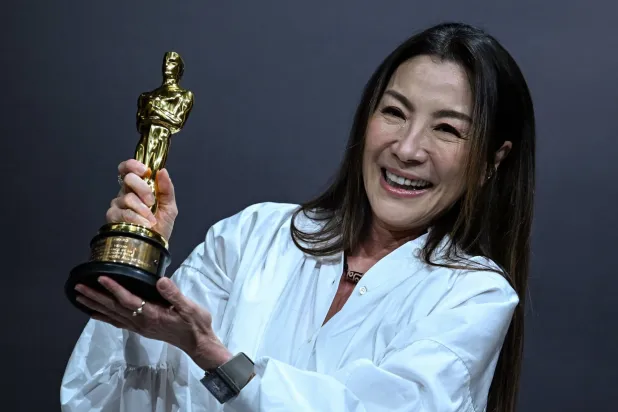 Malaysian actress Michelle Yeoh poses with the Oscar for Best Actress in a Leading Role for "Everything Everywhere All at Once" during a press conference in Kuala Lumpur on April 18, 2023. (AFP)