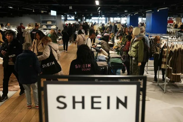 Customers shop on the opening day of Asian e-commerce giant Shein's first physical store at the Bazar de l'Hotel de Ville (BHV) department store in Paris on November 5, 2025. (AFP)