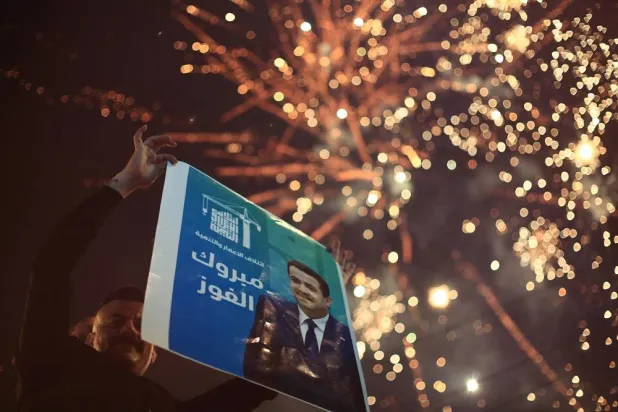 12 November 2025, Iraq, Baghdad: A supporter of Iraqi Prime Minister Mohammed Shia al-Sudani celebrates in Tahrir Square, following the announcement of preliminary election results in Baghdad. (dpa)