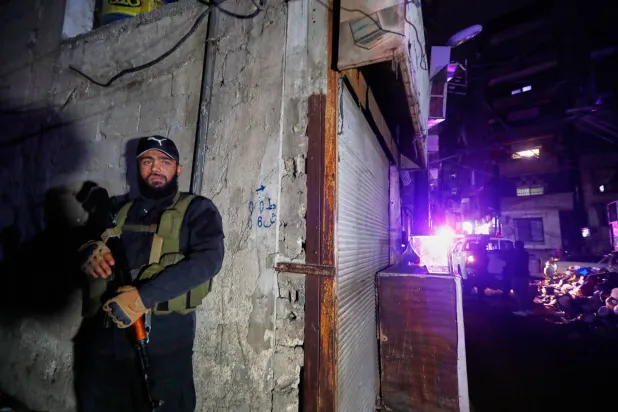 Syrian security forces secure the area around a building that, according to state media, was hit by rockets Friday, Nov. 14, 2025. (AP Photo/Omar Sanadiki)