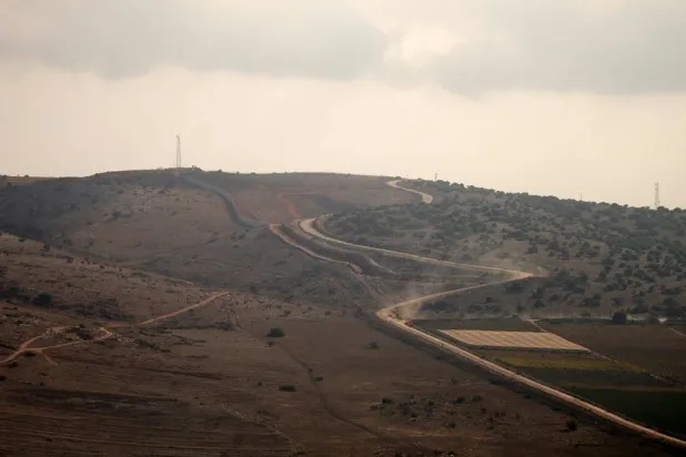 A photograph taken from the southern Lebanese village of Maroun al-Ras shows a concrete barrier wall that the Israeli army began constructing south of the Blue Line, which separates Lebanon and Israel, between the northern Israeli village of Avivim and the Lebanese area of Jal al-Deir, on November 12, 2025. (AFP)