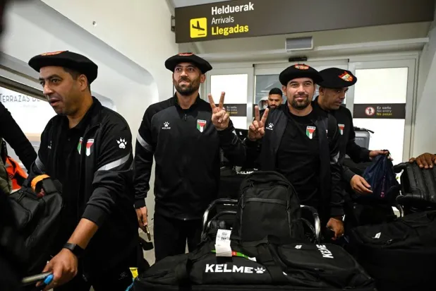 Palestinian national football team members wear the traditional Basque "txapela" (beret) as they arrive at Bilbao airport ahead of their friendly match against the Basque national team in Bilbao on November 11, 2025. (AFP)