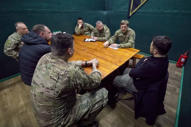 In this photo provided by the Ukrainian Presidential Press Office, Ukrainian President Volodymyr Zelenskyy, right, holds a meeting with servicemen near the frontline city of Pokrovsk, Donetsk region, Ukraine, Tuesday, Nov. 4, 2025. (Ukrainian Presidential Press Office via AP)