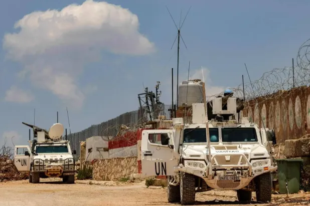 Peacekeepers of the United Nations Interim Force in Lebanon (UNIFIL) ride in armored vehicles during a patrol along the border with Israel by the village of Kfar Kila in south Lebanon on June 4, 2025. (AFP)

