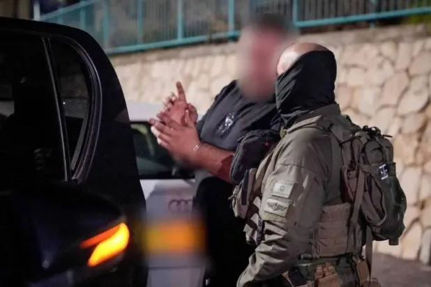 An Israeli man is detained on suspicion of spying for Iran in a photo released on December 9, 2024. (Israel Police)