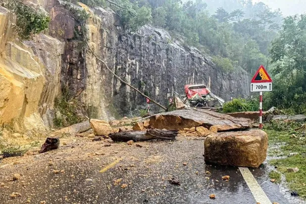 A passenger bus is crushed by a fatal landslide on Khanh Le pass in Khanh Hoa province, Vietnam, Monday, Nov. 17, 2025. (Minh Bang/VNExpress via AP)