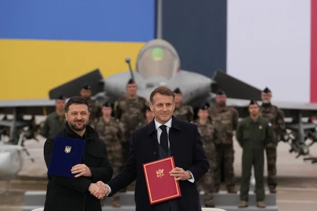 French President Emmanuel Macron and Ukrainian President Volodymyr Zelenskiy shake hands after signing an agreement at the Villacoublay air base near Paris, France, November 17, 2025. (Reuters)