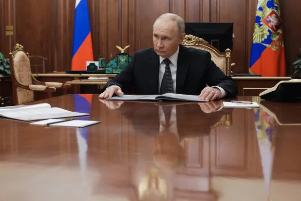 Russian President Vladimir Putin listens to the Astrakhan Region Governor Igor Babushkin at the Kremlin in Moscow, Russia, Thursday, Nov. 13, 2025. (Gavriil Grigorov/Sputnik, Kremlin Pool Photo via AP)