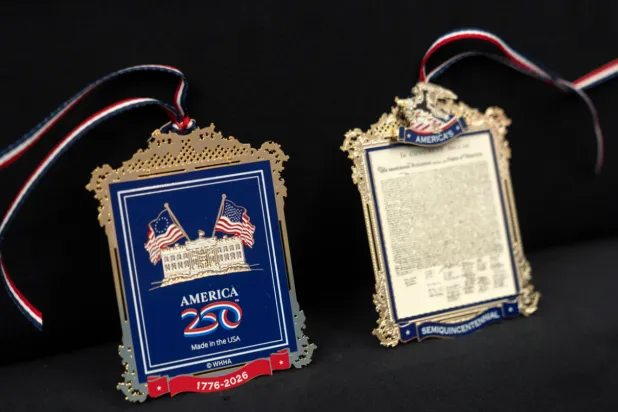 The front and back of a commemorative ornament released by America250 as part of events leading up to the 250th anniversary of the signing of the Declaration of Independence in 1776, is photographed Thursday, Nov. 13, 2025, in Washington. (AP Photo/Mark Schiefelbein)
